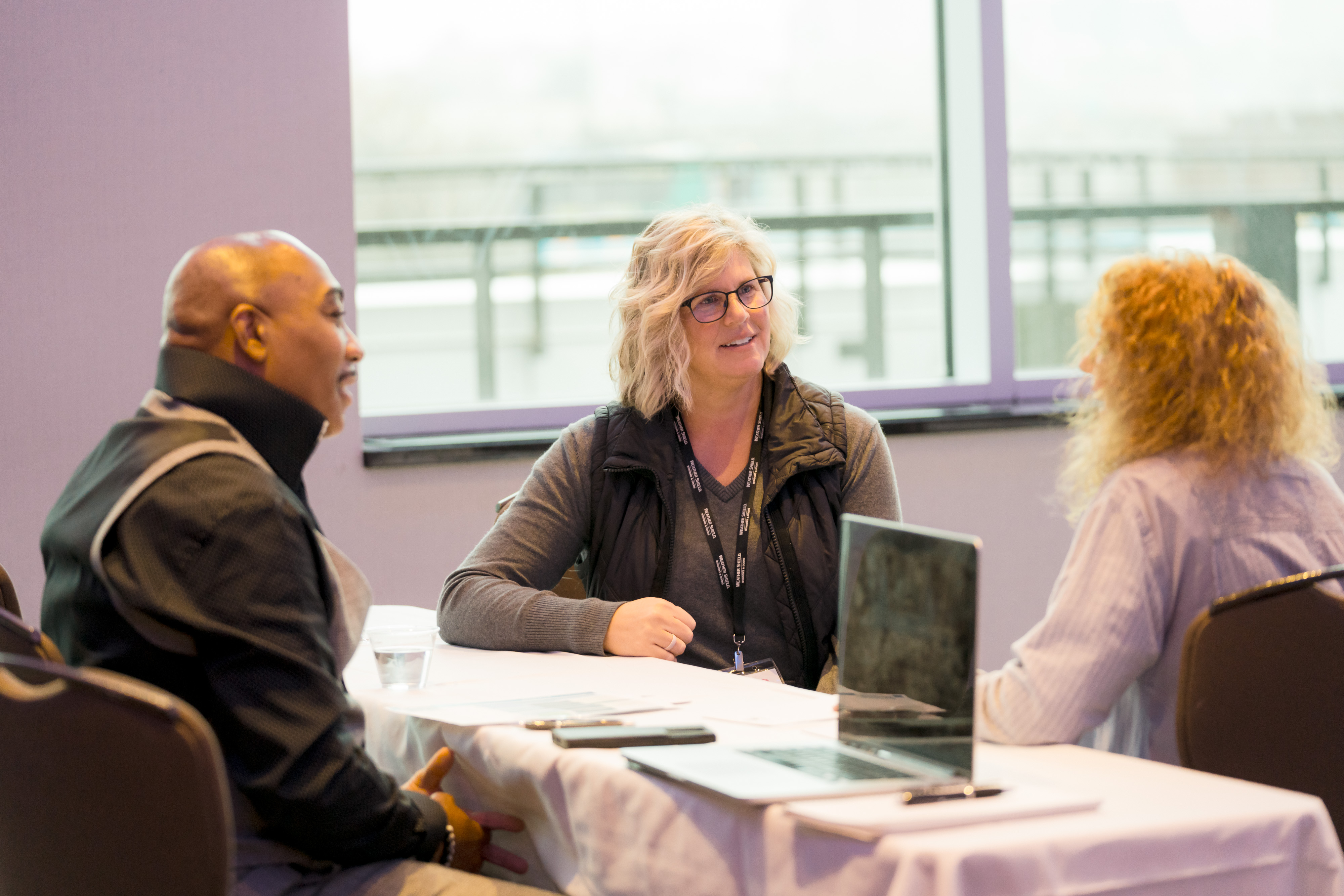 Small-group coaching conversation at a table