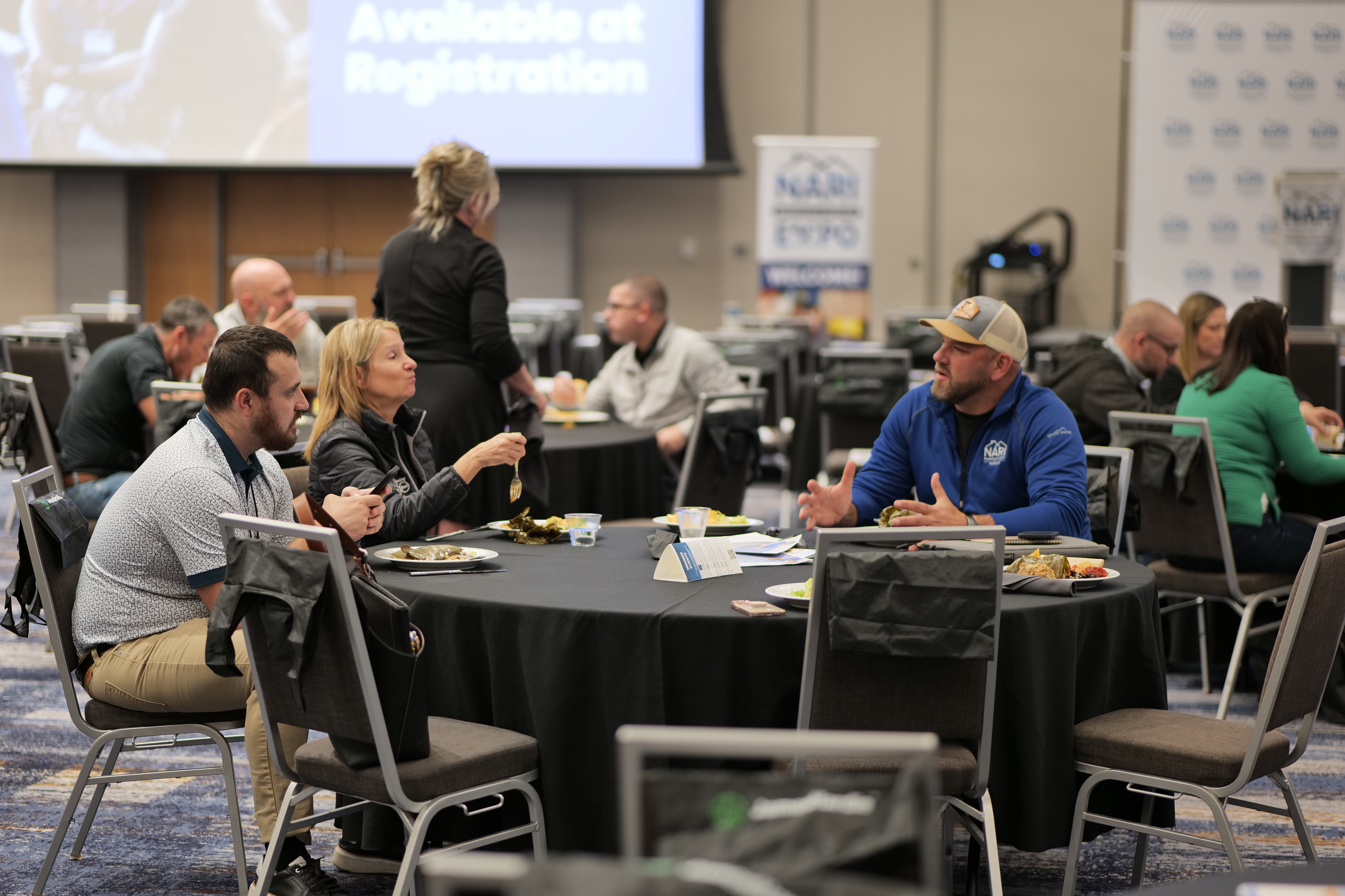 Remodelers talking around a table over lunch